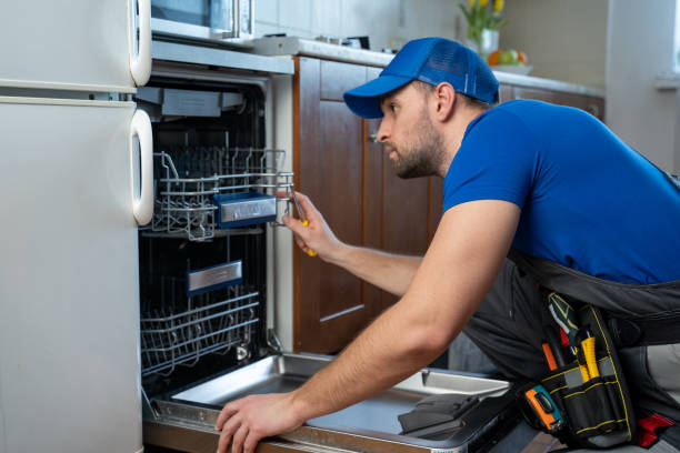 Technician inspecting the racks and interior of a residential dishwasher
